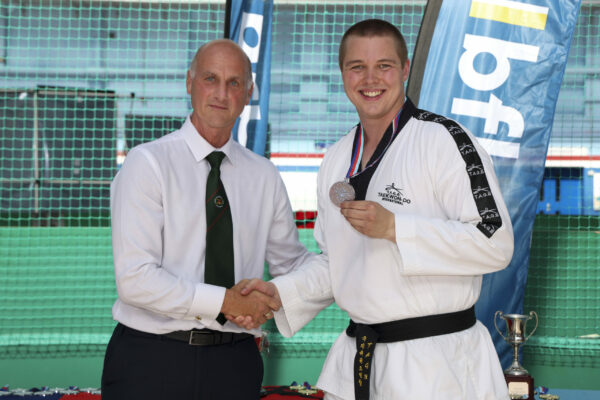 Pictured: British Army LCpl Penbroke wins silver for dan grade heavyweight sparring ITF Competition during the Inter Services Martial Arts Championship 2022 held at HMS Nelson. 

MARTIAL ARTS INTER SERVICES CHAMPIONSHIP 2022

On 16th-17th July 2022, the Royal Navy Royal Marines Mixed Martial Arts Association hosted the Martial Arts Inter Services Championship 2022 at HMS Nelson, Portsmouth. It is the first Martial Arts Inter Services Championship since 2019, as COVID-19 discontinued 2020 and 2021 championships. 

Service members from a variety of martial arts disciplines, including Brazilian Jiu-Jitsu (BJJ), World Taekwondo Federation (WT), International Taekwondo Federation (ITF), and Kendo, competed in the Martial Arts Inter Services Championship 2022. The Army Karate team was unable to compete, so a different championship will be held for the Karate team later this year.

International Taekwondo Federation and Kendo competition was held on Saturday, 16th July 2022; World Taekwondo Federation and Brazilian Jiu-Jitsu competition was held on 17th July 2022.  

ITF and WT are quite similar and both have their roots in Korean martial arts, although WT is more of a sport, and ITF is more of a traditional self-defence Four of the 13 competitors in this year's WTF, WO Hewett, LET La Roche, AB Lee, and Cpl Bevan, represented the Royal Navy. Receptively, LET La Roche and AB Lee took home a silver and a gold. There were 14 competitors for the ITF, including WO Hewett, Cpl Bevan, AWW Shepherd, and CS Pedley from the Royal Navy. For the Royal Navy, AWW Shepherd from HMS Raleigh and CS Pedley from HMS Defender each got a gold medal.