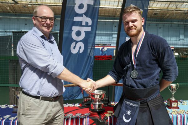 Pictured: AB Nolan wins second place in individual kendo sparring during the  Martial Arts Inter Services Championship 2022 held at HMS Nelson, Portsmouth. 

MARTIAL ARTS INTER SERVICES CHAMPIONSHIP 2022

On 16th-17th July 2022, the Royal Navy Royal Marines Mixed Martial Arts Association hosted the Martial Arts Inter Services Championship 2022 at HMS Nelson, Portsmouth. It is the first Martial Arts Inter Services Championship since 2019, as COVID-19 discontinued 2020 and 2021 championships. 

Service members from a variety of martial arts disciplines, including Brazilian Jiu-Jitsu (BJJ), World Taekwondo Federation (WT), International Taekwondo Federation (ITF), and Kendo, competed in the Martial Arts Inter Services Championship 2022. The Army Karate team was unable to compete, so a different championship will be held for the Karate team later this year.

International Taekwondo Federation and Kendo competition was held on Saturday, 16th July 2022; World Taekwondo Federation and Brazilian Jiu-Jitsu competition was held on 17th July 2022.  

Kendo is a modern Japanese martial art, descended from kenjutsu, one of traditional Japanese martial arts, swordsmanship, that is bamboo swords as well as protective armour. Kendo competition consist of 3 Royal Navy and 3 Army competitors. AB Nolan, AB Howell and Major Bowlem won gold for team sparring and AB Nolan won gold for kata.