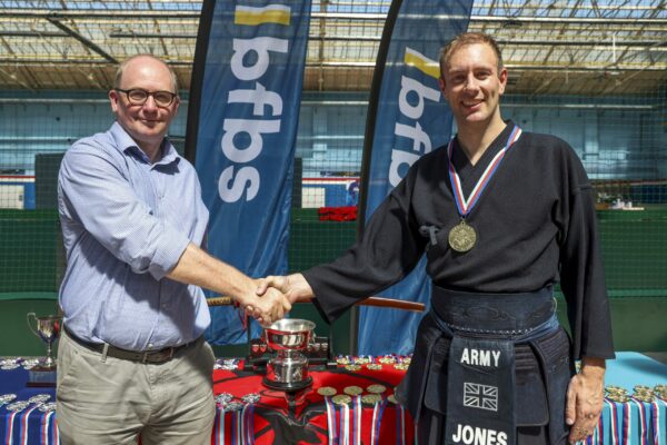 Pictured: Major Jones from the British Army wins gold in the individual kendo sparring during the  Martial Arts Inter Services Championship 2022 held at HMS Nelson, Portsmouth. 

MARTIAL ARTS INTER SERVICES CHAMPIONSHIP 2022

On 16th-17th July 2022, the Royal Navy Royal Marines Mixed Martial Arts Association hosted the Martial Arts Inter Services Championship 2022 at HMS Nelson, Portsmouth. It is the first Martial Arts Inter Services Championship since 2019, as COVID-19 discontinued 2020 and 2021 championships. 

Service members from a variety of martial arts disciplines, including Brazilian Jiu-Jitsu (BJJ), World Taekwondo Federation (WT), International Taekwondo Federation (ITF), and Kendo, competed in the Martial Arts Inter Services Championship 2022. The Army Karate team was unable to compete, so a different championship will be held for the Karate team later this year.

International Taekwondo Federation and Kendo competition was held on Saturday, 16th July 2022; World Taekwondo Federation and Brazilian Jiu-Jitsu competition was held on 17th July 2022.  

Kendo is a modern Japanese martial art, descended from kenjutsu, one of traditional Japanese martial arts, swordsmanship, that is bamboo swords as well as protective armour. Kendo competition consist of 3 Royal Navy and 3 Army competitors. AB Nolan, AB Howell and Major Bowlem won gold for team sparring and AB Nolan won gold for kata.