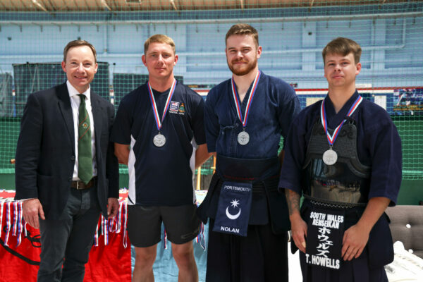 Pictured: Royal Navy Kendo Team win silver medal for team sparing during the Martial Arts Inter Services Championship 2022 held at HMS Nelson, Portsmouth. 

MARTIAL ARTS INTER SERVICES CHAMPIONSHIP 2022

On 16th-17th July 2022, the Royal Navy Royal Marines Mixed Martial Arts Association hosted the Martial Arts Inter Services Championship 2022 at HMS Nelson, Portsmouth. It is the first Martial Arts Inter Services Championship since 2019, as COVID-19 discontinued 2020 and 2021 championships. 

Service members from a variety of martial arts disciplines, including Brazilian Jiu-Jitsu (BJJ), World Taekwondo Federation (WT), International Taekwondo Federation (ITF), and Kendo, competed in the Martial Arts Inter Services Championship 2022. The Army Karate team was unable to compete, so a different championship will be held for the Karate team later this year.

International Taekwondo Federation and Kendo competition was held on Saturday, 16th July 2022; World Taekwondo Federation and Brazilian Jiu-Jitsu competition was held on 17th July 2022.  

Kendo is a modern Japanese martial art, descended from kenjutsu, one of traditional Japanese martial arts, swordsmanship, that is bamboo swords as well as protective armour. Kendo competition consist of 3 Royal Navy and 3 Army competitors. AB Nolan, AB Howell and Major Bowlem won gold for team sparring and AB Nolan won gold for kata.
