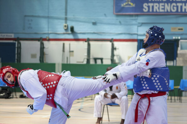 Pictured: World Taekwondo Competition during the Martial Arts Inter Services Championship 2022 held at HMS Nelson, Portsmouth. 

MARTIAL ARTS INTER SERVICES CHAMPIONSHIP 2022

On 16th-17th July 2022, the Royal Navy Royal Marines Mixed Martial Arts Association hosted the Martial Arts Inter Services Championship 2022 at HMS Nelson, Portsmouth. It is the first Martial Arts Inter Services Championship since 2019, as COVID-19 discontinued 2020 and 2021 championships. 

Service members from a variety of martial arts disciplines, including Brazilian Jiu-Jitsu (BJJ), World Taekwondo Federation (WT), International Taekwondo Federation (ITF), and Kendo, competed in the Martial Arts Inter Services Championship 2022. The Army Karate team was unable to compete, so a different championship will be held for the Karate team later this year.

International Taekwondo Federation and Kendo competition was held on Saturday, 16th July 2022; World Taekwondo Federation and Brazilian Jiu-Jitsu competition was held on 17th July 2022.  

ITF and WT are quite similar and both have their roots in Korean martial arts, although WT is more of a sport, and ITF is more of a traditional self-defense. Four of the 13 competitors in this year's WTF, WO Hewett, LET La Roche, AB Lee, and Cpl Bevan, represented the Royal Navy. Receptively, LET La Roche and AB Lee took home a silver and a gold. There were 14 competitors for the ITF, including WO Hewett, Cpl Bevan, AWW Shepherd, and CS Pedley from the Royal Navy. For the Royal Navy, AWW Shepherd from HMS Raleigh and CS Pedley from HMS Defender each got a gold medal.